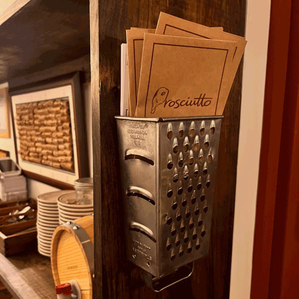 Legs of cured prosciutto hanging in a traditional Italian style